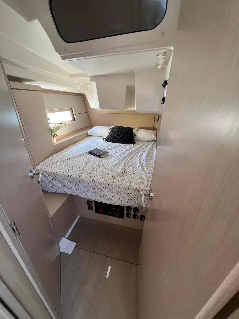 Slide: The Image of Cozy cabin interior of 2020 Beneteau Oceanis 46.1 sailboat with bed and porthole. - 27
