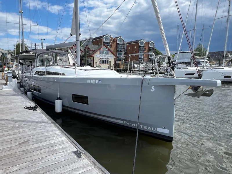 Slide: The Image of 2020 Beneteau Oceanis 46.1 yacht docked at marina, clear sky, waterfront buildings. - 3