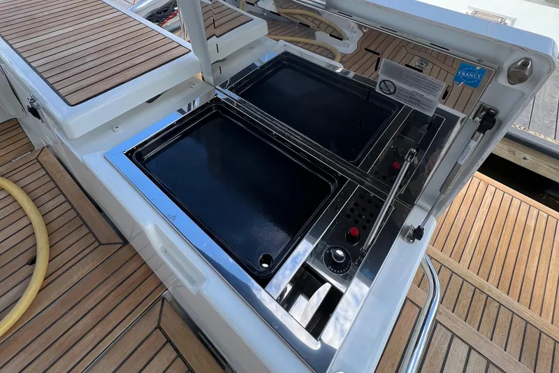 Slide: The Image of Beneteau Oceanis 46.1 2020 yacht deck with built-in grill and wooden flooring. - 34