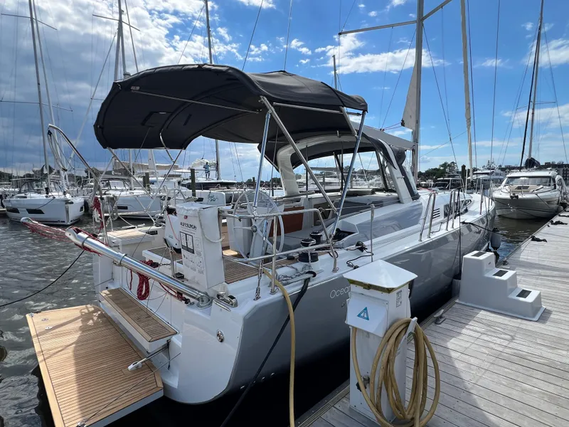 Slide: The Image of 2020 Beneteau Oceanis 46.1 yacht docked at marina under blue sky. - 4