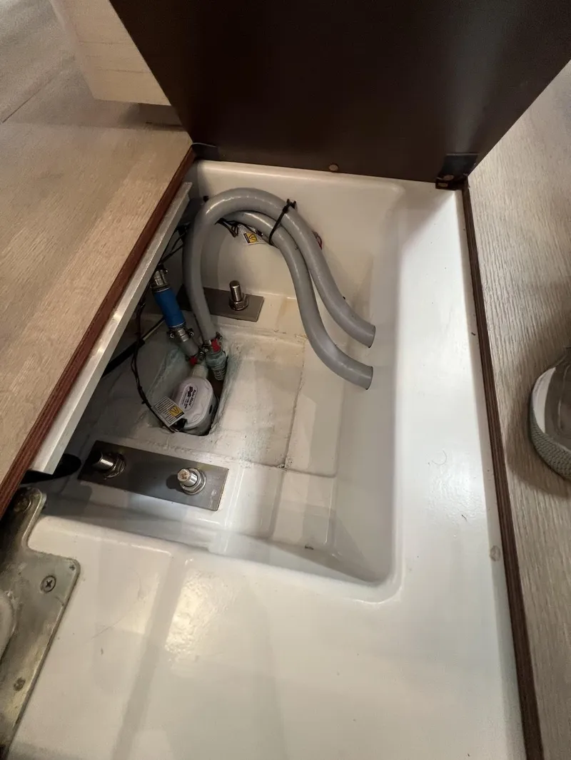 Slide: The Image of 2020 Beneteau Oceanis 46.1 yacht interior compartment with plumbing and wiring. - 40