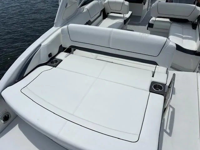 Slide: The Image of 2025 Formula 290 Bowrider boat with spacious white seating and cup holders. - 4