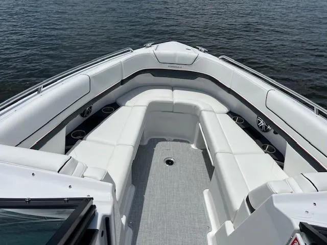 Slide: The Image of 2025 Formula 290 Bowrider boat with spacious seating on calm water. - 7