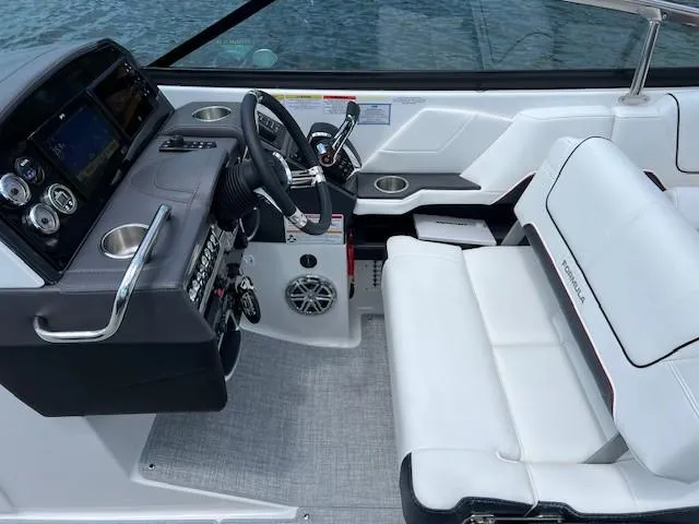 Slide: The Image of Interior cockpit of 2025 Formula 290 Bowrider boat with white seating and modern controls. - 9