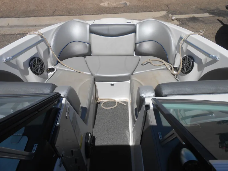 Slide: The Image of 2016 MasterCraft X23 boat interior with gray seating and speakers. - 10