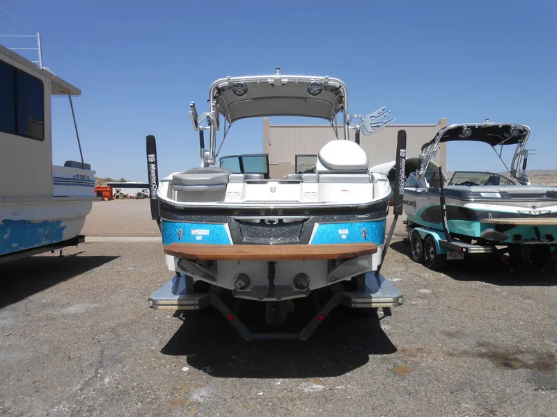 Slide: The Image of 2016 MasterCraft X23 boat, rear view, parked on a sunny day. - 3