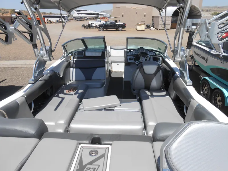 Slide: The Image of 2016 MasterCraft X23 boat interior with gray seating and modern dashboard. - 5