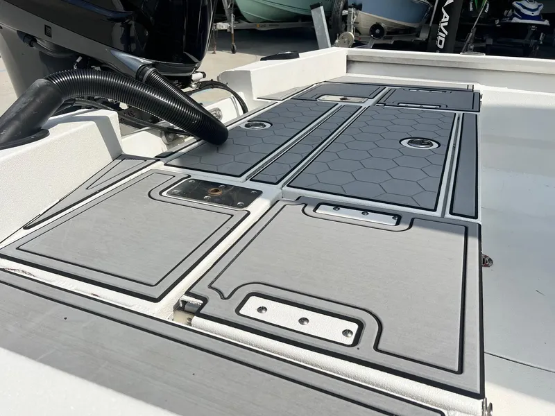Slide: The Image of Avid 23 Mag 2022 boat deck with storage compartments and non-slip surface. - 2