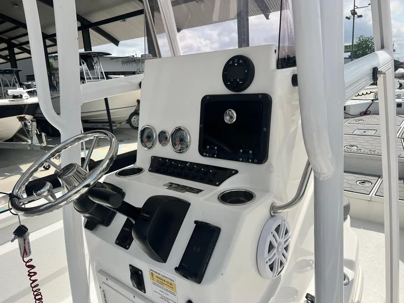 Slide: The Image of Control console of 2022 Avid 23 Mag boat with steering wheel and gauges. - 3