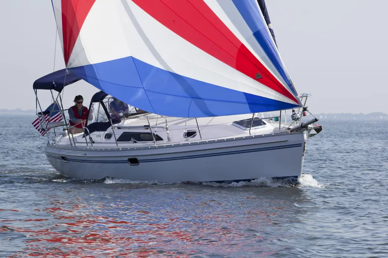 Slide: The Image of 2024 Catalina 355 sailboat with colorful spinnaker sailing on calm waters. - 18