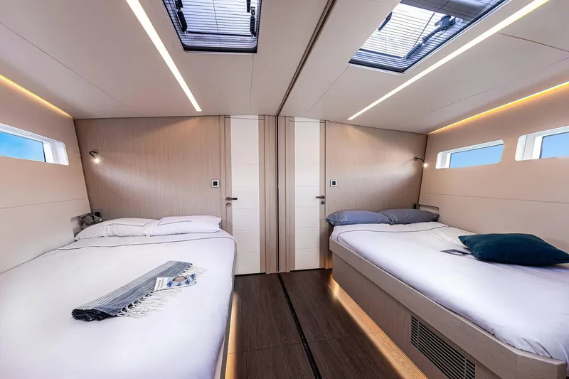 Slide: The Image of Modern cabin interior of 2024 Jeanneau 60 yacht with twin beds and skylights. - 26