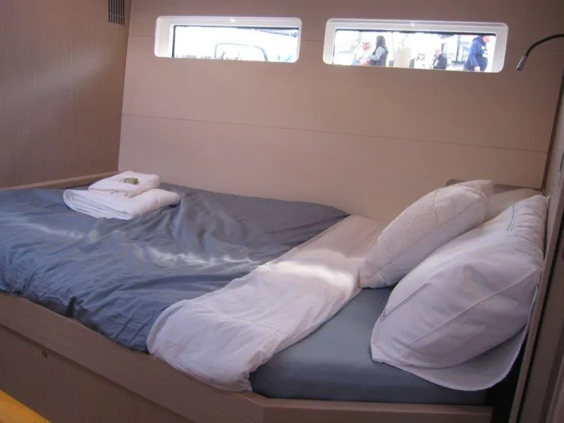 Slide: The Image of Luxurious bedroom in 2024 Jeanneau 60 yacht with cozy bedding and natural light. - 30