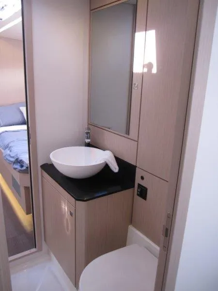 Slide: The Image of 2024 Jeanneau 60 yacht bathroom with modern sink and cabinetry. - 35