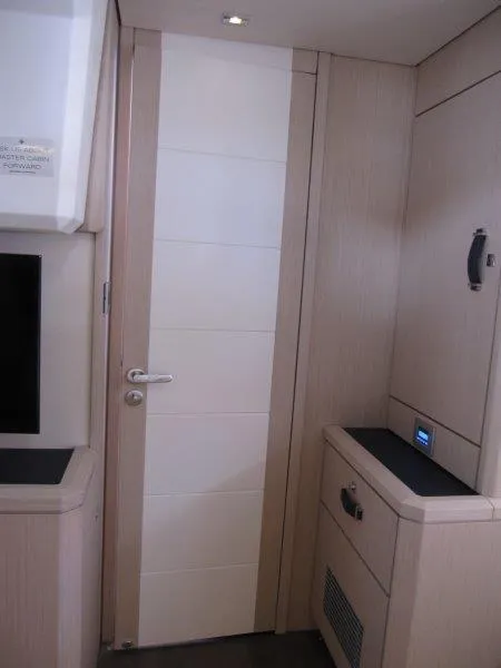 Slide: The Image of Interior of 2024 Jeanneau 60 yacht, featuring modern cabinetry and sleek door design. - 46