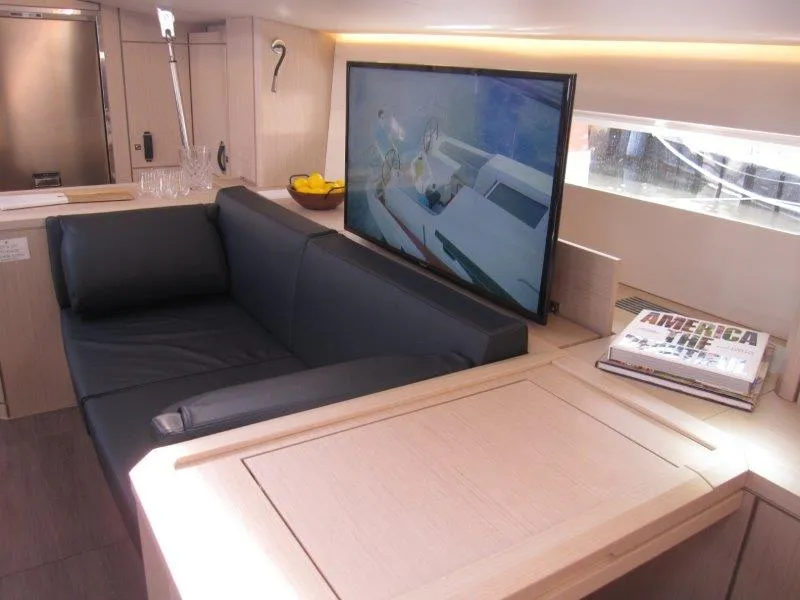 Slide: The Image of Luxurious interior of 2024 Jeanneau 60 yacht with modern sofa and TV. - 6