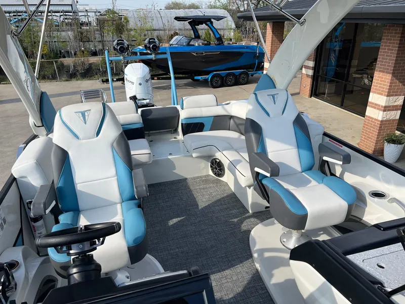 Slide: The Image of 2024 Trifecta 25 SPORT RL9 DC 3PLUS ARCH boat interior with blue and white seating. - 12