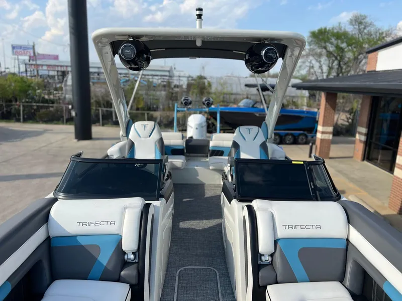 Slide: The Image of 2024 Trifecta 25 SPORT RL9 DC 3PLUS ARCH boat interior with modern seating and sleek design. - 14
