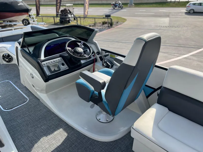 Slide: The Image of 2024 Trifecta 25 SPORT RL9 DC 3PLUS ARCH boat cockpit with modern steering and seating. - 16