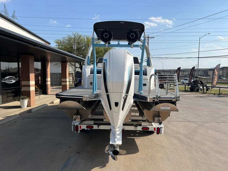 Slide: The Image of 2024 Trifecta 25 SPORT RL9 DC 3PLUS ARCH boat, rear view, parked outdoors. - 4