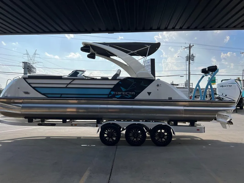 Slide: The Image of 2024 Trifecta 25 SPORT RL9 DC 3PLUS ARCH pontoon boat on trailer, side view. - 6