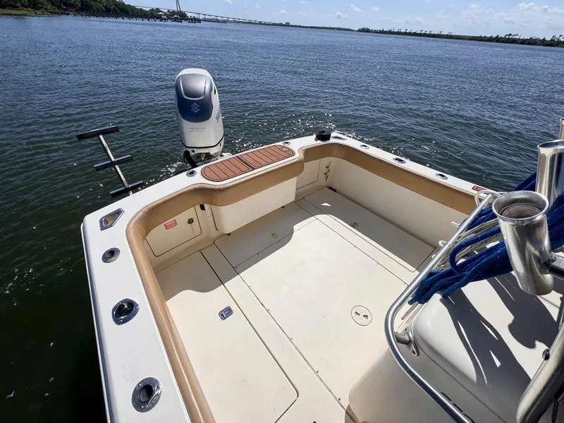 Slide: The Image of 2002 Scout 280 Sportfish boat stern with outboard motor on calm water. - 12