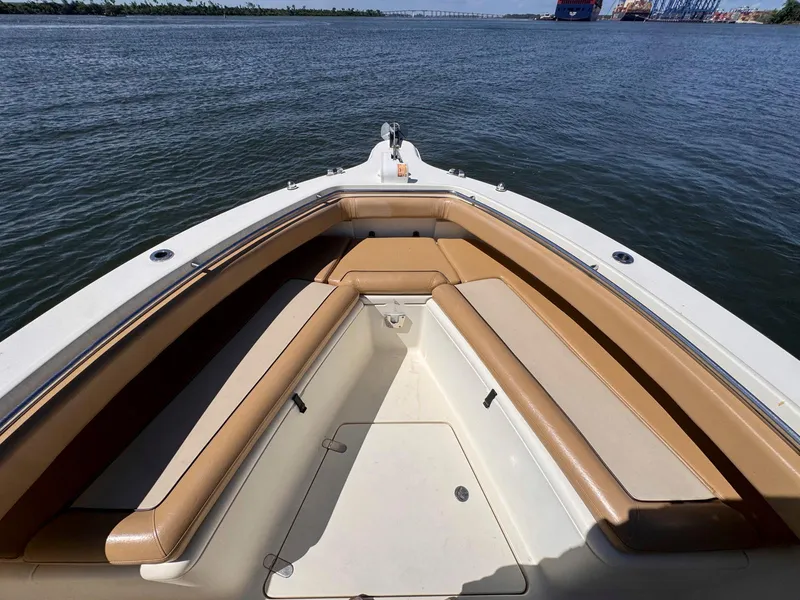 Slide: The Image of 2002 Scout 280 Sportfish boat bow seating area on calm water. - 14