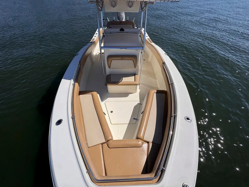 Slide: The Image of 2002 Scout 280 Sportfish boat with tan seating on calm water. - 15