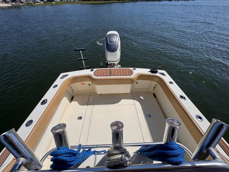 Slide: The Image of 2002 Scout 280 Sportfish boat stern view with outboard motor on water. - 19