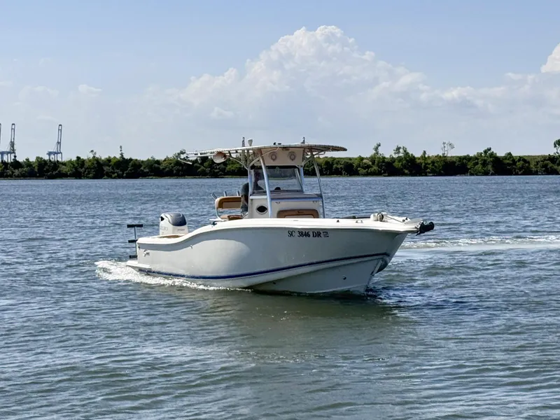 Slide: The Image of 2002 Scout 280 Sportfish boat cruising on a calm lake. - 2