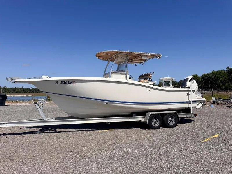 Slide: The Image of 2002 Scout 280 Sportfish boat on a trailer under a clear blue sky. - 3