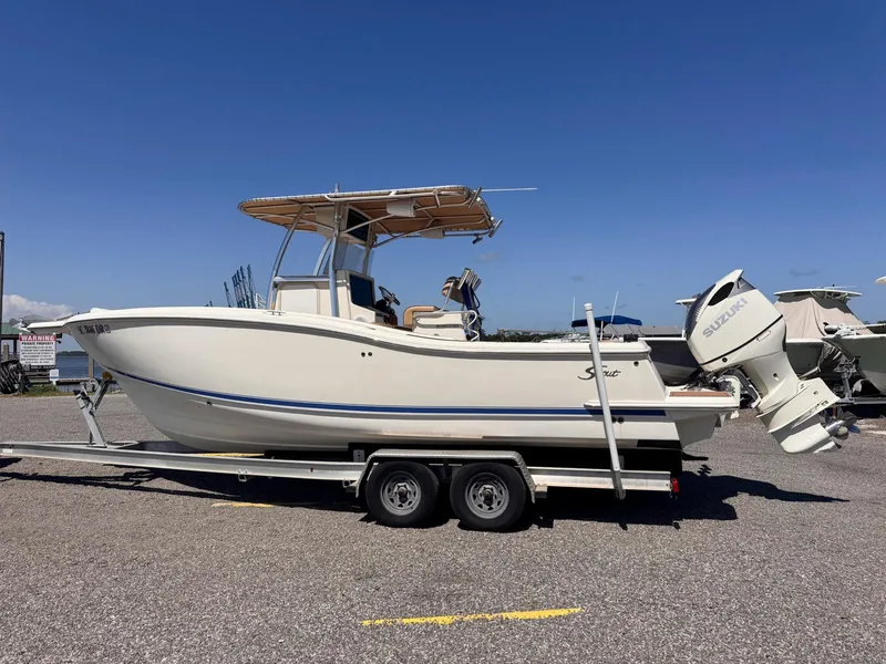 Slide: The Image of 2002 Scout 280 Sportfish boat on trailer, side view, clear sky background. - 4