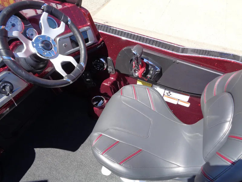 Slide: The Image of 2024 Nitro ZV20 boat cockpit with steering wheel and captain's seat. - 12