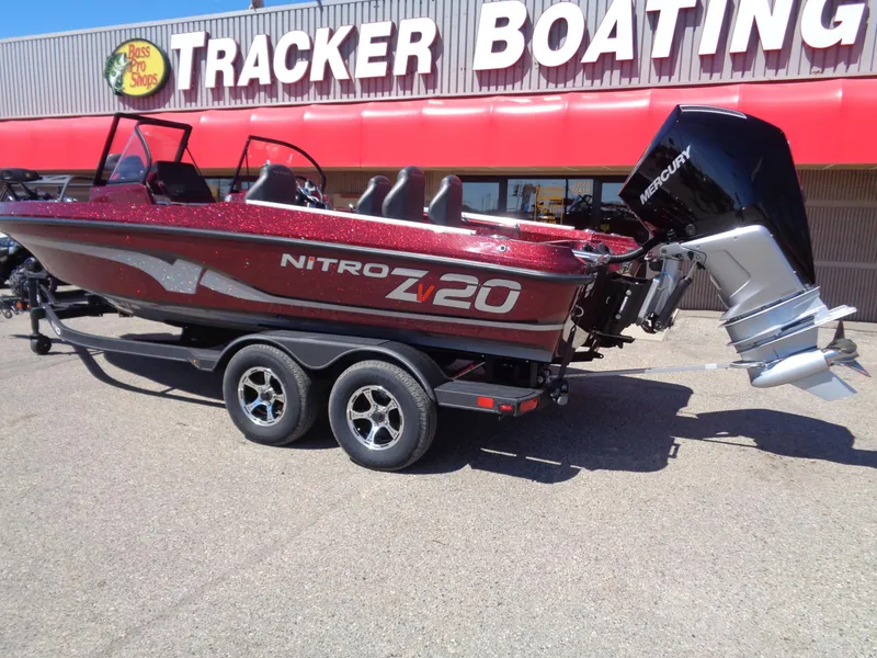 Slide: The Image of 2024 Nitro ZV20 boat on trailer outside Tracker Boating store. - 2