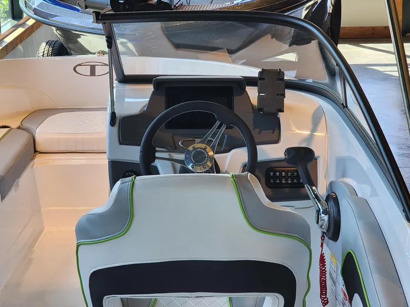Slide: The Image of 2024 Tahoe 210 Si boat interior with steering wheel and seating. - 4