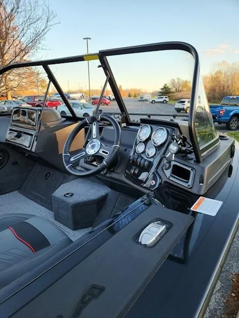 Slide: The Image of 2024 Tracker Targa V-18 WT boat interior with steering wheel and dashboard controls. - 3