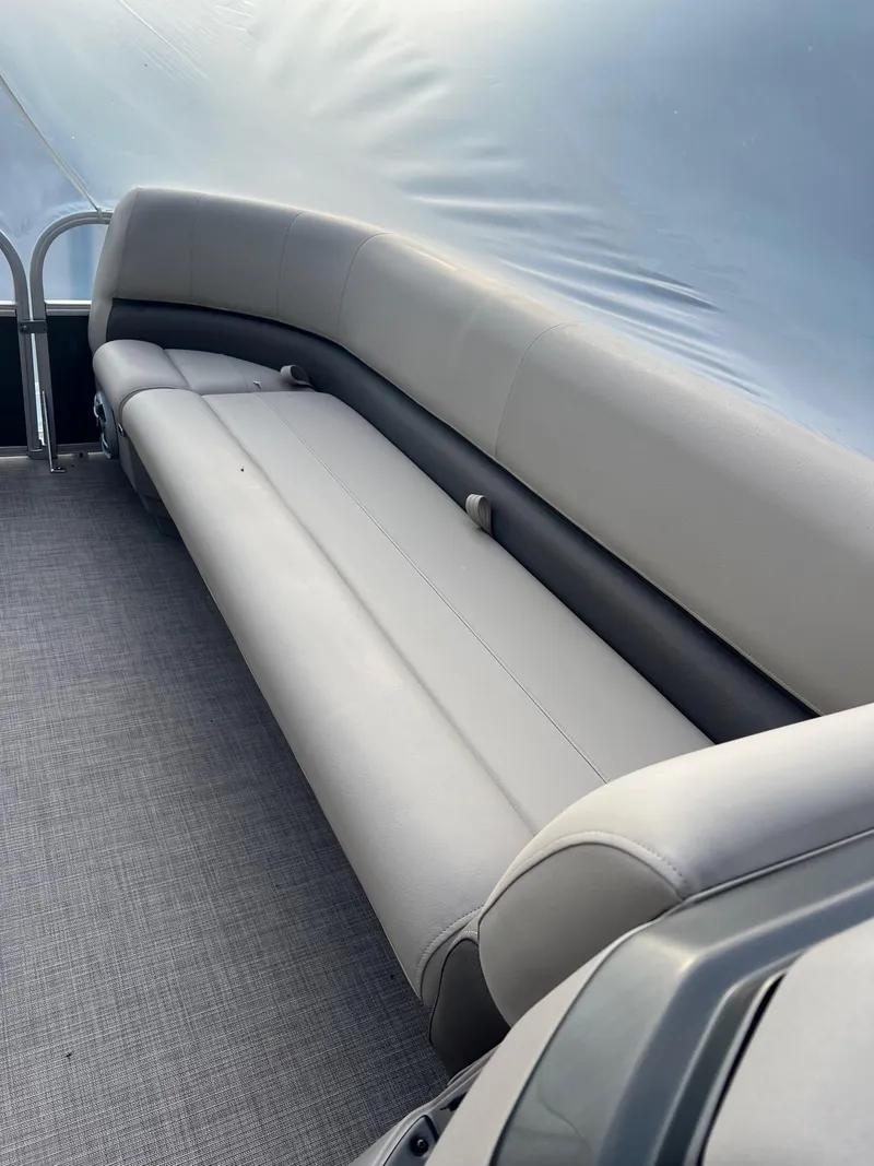 Slide: The Image of 2024 Sun Tracker Party Barge 18 DLX interior seating with gray upholstery. - 5