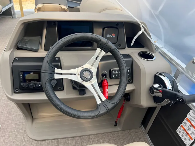 Slide: The Image of 2024 Sun Tracker Fishin' Barge 20 DLX steering console with modern controls and dashboard. - 4