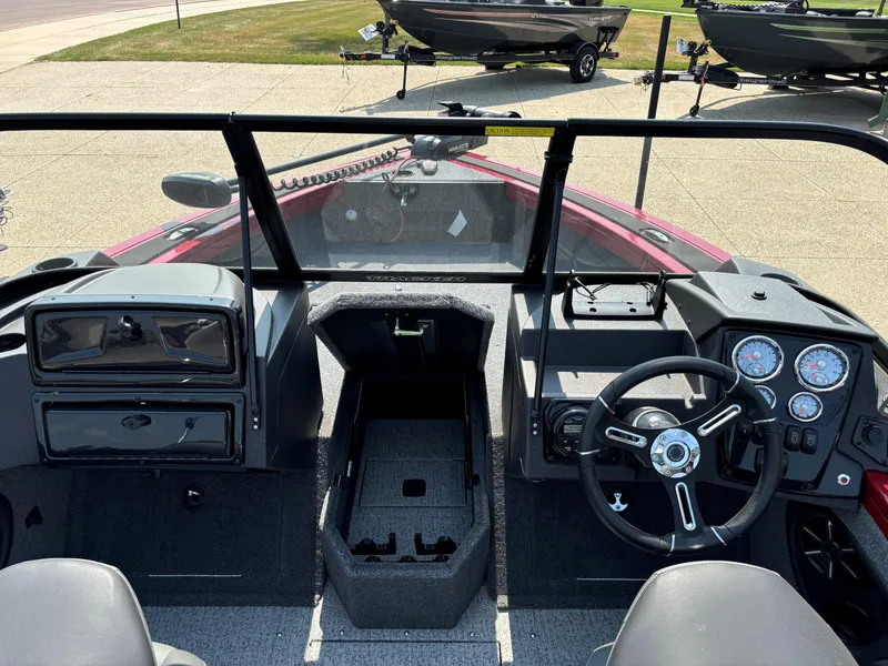 Slide: The Image of 2024 Tracker Targa V-18 WT boat interior with steering wheel and dashboard controls. - 6