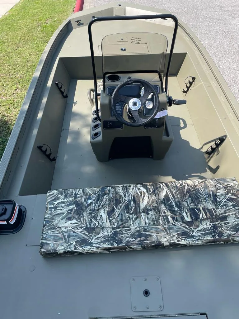 Slide: The Image of 2024 Tracker Grizzly 1860 CC boat interior with steering console and camouflage seat. - 3