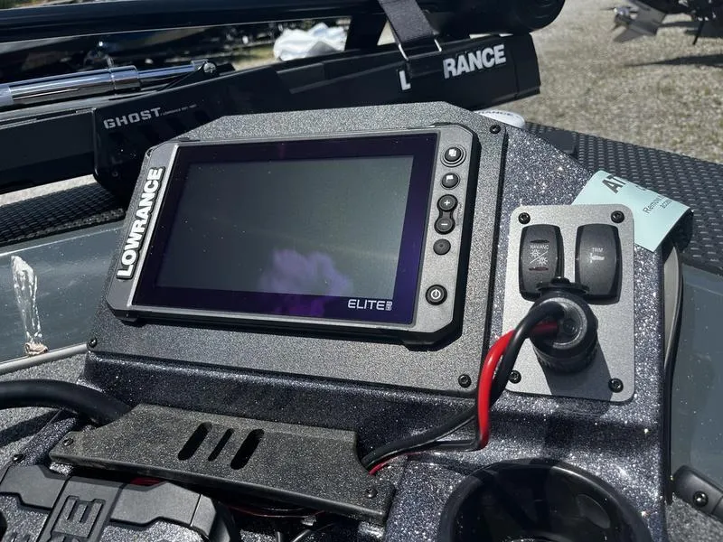 Slide: The Image of 2024 Ranger RT188P boat dashboard with Lowrance Elite fishfinder and control switches. - 2