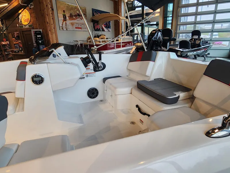 Slide: The Image of 2024 Tahoe T16 boat interior with seating and steering wheel in showroom. - 4