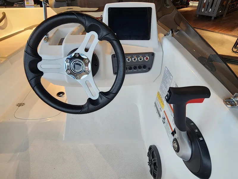 Slide: The Image of 2024 Tahoe T16 boat cockpit with steering wheel, control panel, and throttle lever. - 5