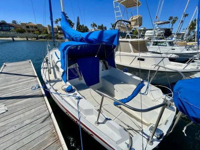 Slide: The Image of 1973 Ericson 27 sailboat docked at marina with blue covers. - 10