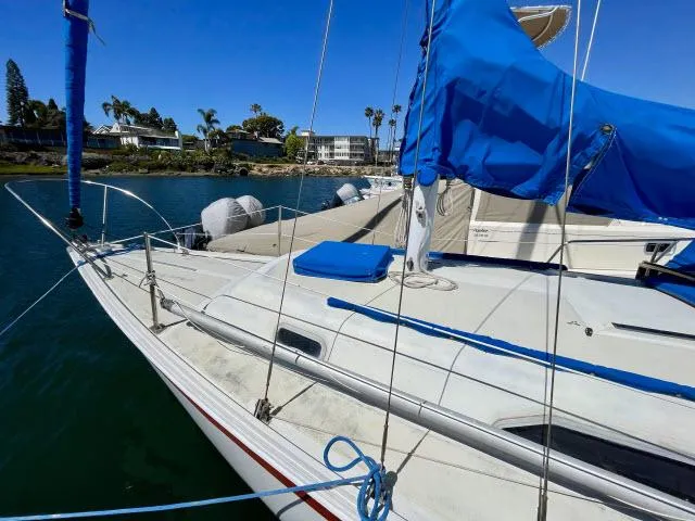 Slide: The Image of 1973 Ericson 27 sailboat docked with blue sail cover. - 12