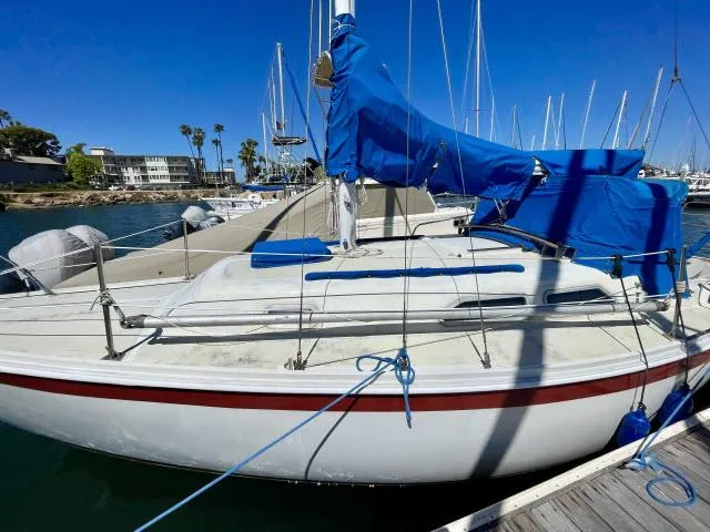 Slide: The Image of 1973 Ericson 27 sailboat docked at marina with blue covers. - 17