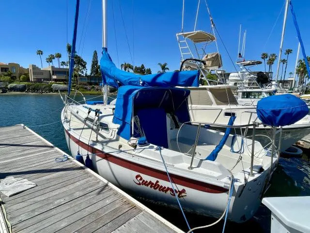 Slide: The Image of 1973 Ericson 27 sailboat named Sunburst docked at a marina. - 18