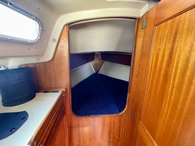 Slide: The Image of 1973 Ericson 27 sailboat interior with wooden cabinetry and cozy sleeping quarters. - 5