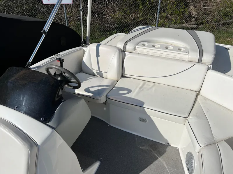 Slide: The Image of 2011 Bayliner 197 boat interior with white seating and steering wheel. - 10