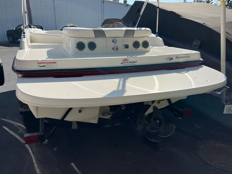 Slide: The Image of 2011 Bayliner 197 boat rear view with swim platform and outboard motor. - 12
