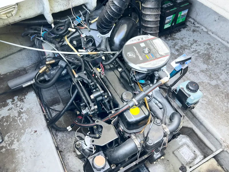Slide: The Image of Engine compartment of a 2011 Bayliner 197 boat with visible wiring and components. - 14